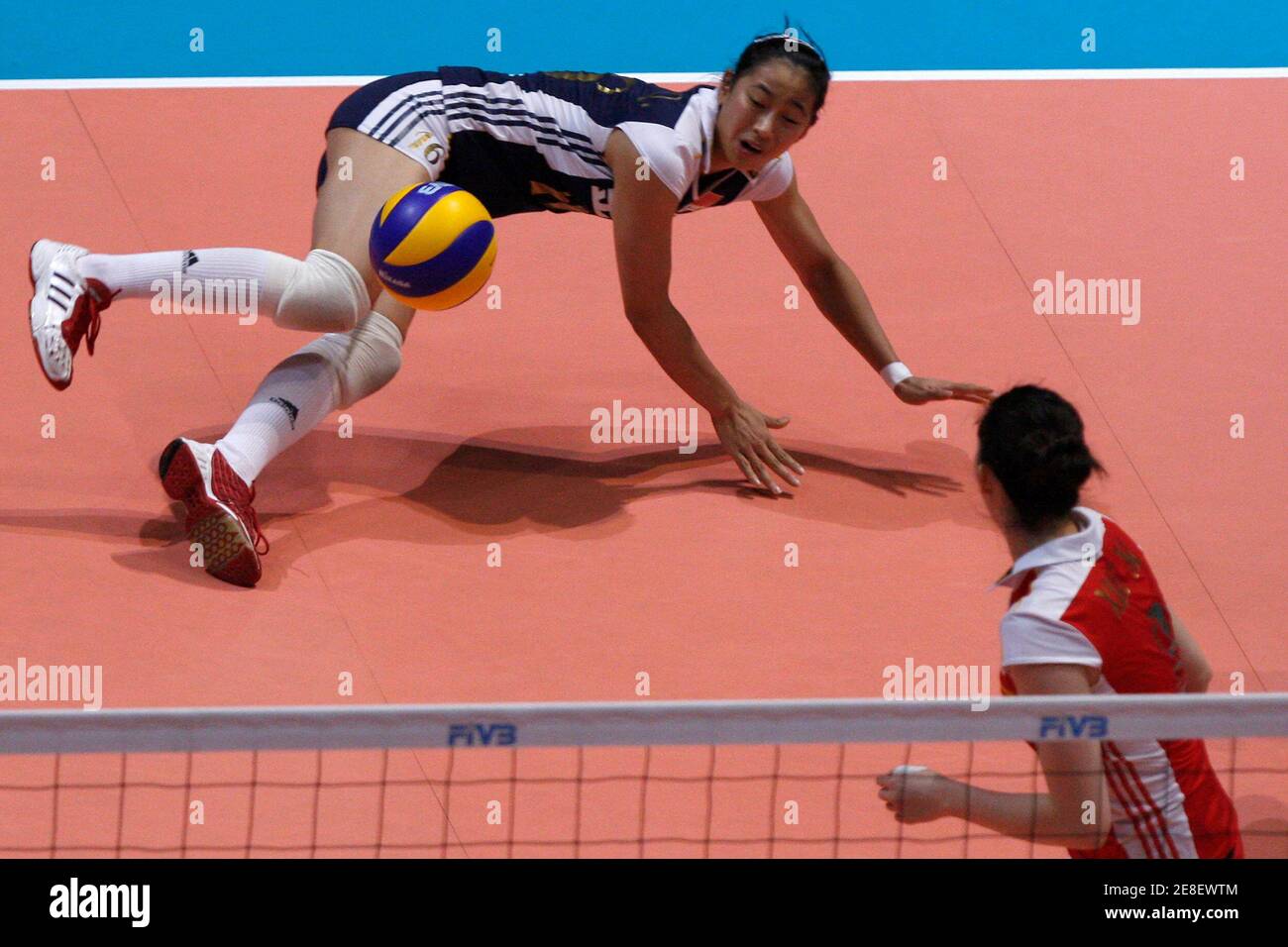 Chu Jinling (top) of China falls on the court during a match against Dominican Republic at the FIVB World Grand Prix women's volleyball tournament in Hong Kong August 14, 2009.    REUTERS/Tyrone Siu    (CHINA SPORT VOLLEYBALL) Stock Photo