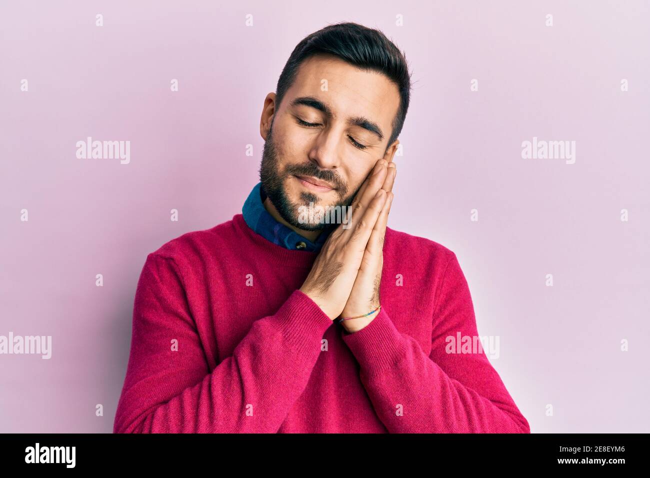 Young hispanic man wearing casual clothes sleeping tired dreaming and ...