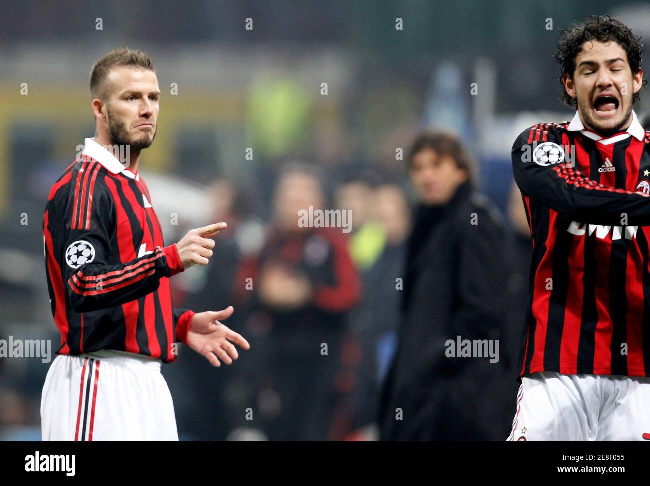 AC Milan's David Beckham (L) and Alexandre Pato react after Ronaldinho (not  seen) scores against Manchester United during their Champions League soccer  match at the San Siro stadium in Milan February 16,