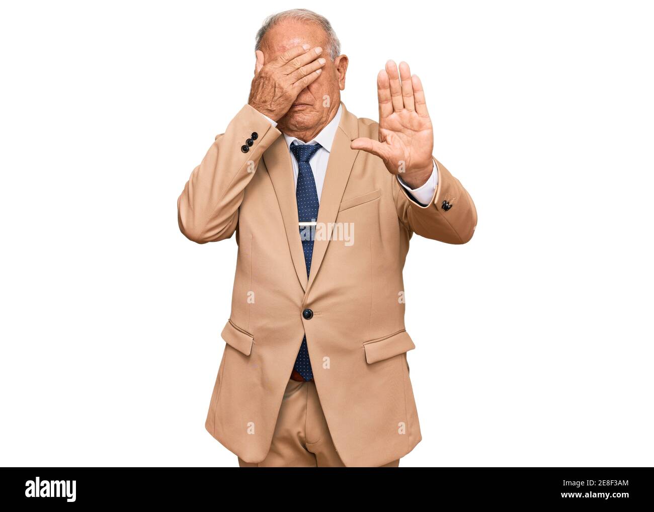 Senior caucasian man wearing business suit and tie covering eyes with hands and doing stop gesture with sad and fear expression. embarrassed and negat Stock Photo