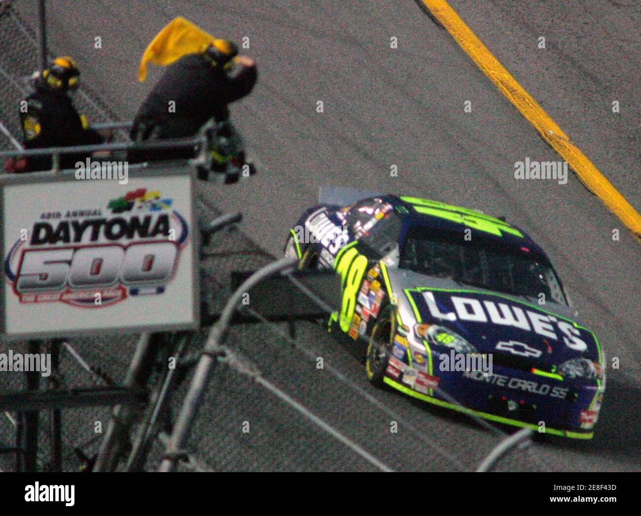 Jimmie Johnson in the number 48 Chevrolet takes the checkered flag to win the 48th Daytona 500 race at the Daytona International Speedway in Daytona Beach, Florida February 19, 2006. REUTERS/Rick Fowler Stock Photo