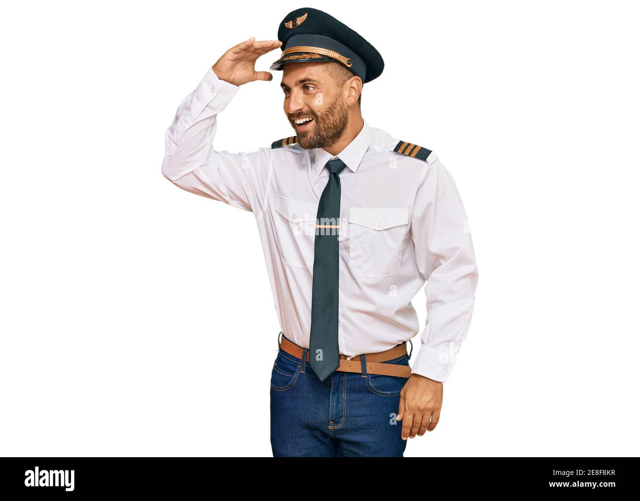 Handsome man with beard wearing airplane pilot uniform very happy and ...