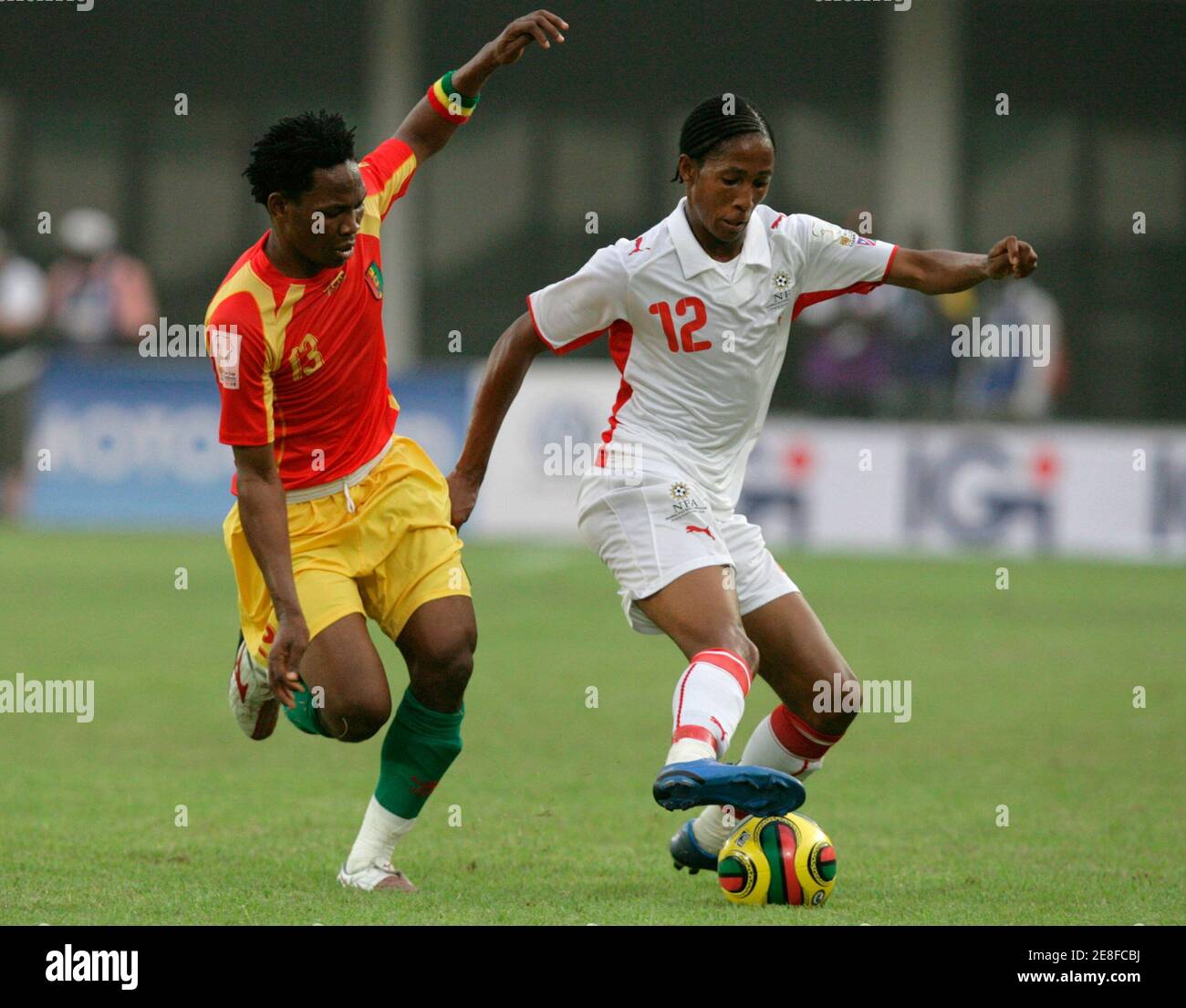 Guinea's Mohamed Sacko (L) fights for the ball with Namibia's Muna Katupose during their African Nations Cup Group A soccer match in Sekondi January 28, 2008.  REUTERS/Siphiwe Sibeko (GHANA) Stock Photo