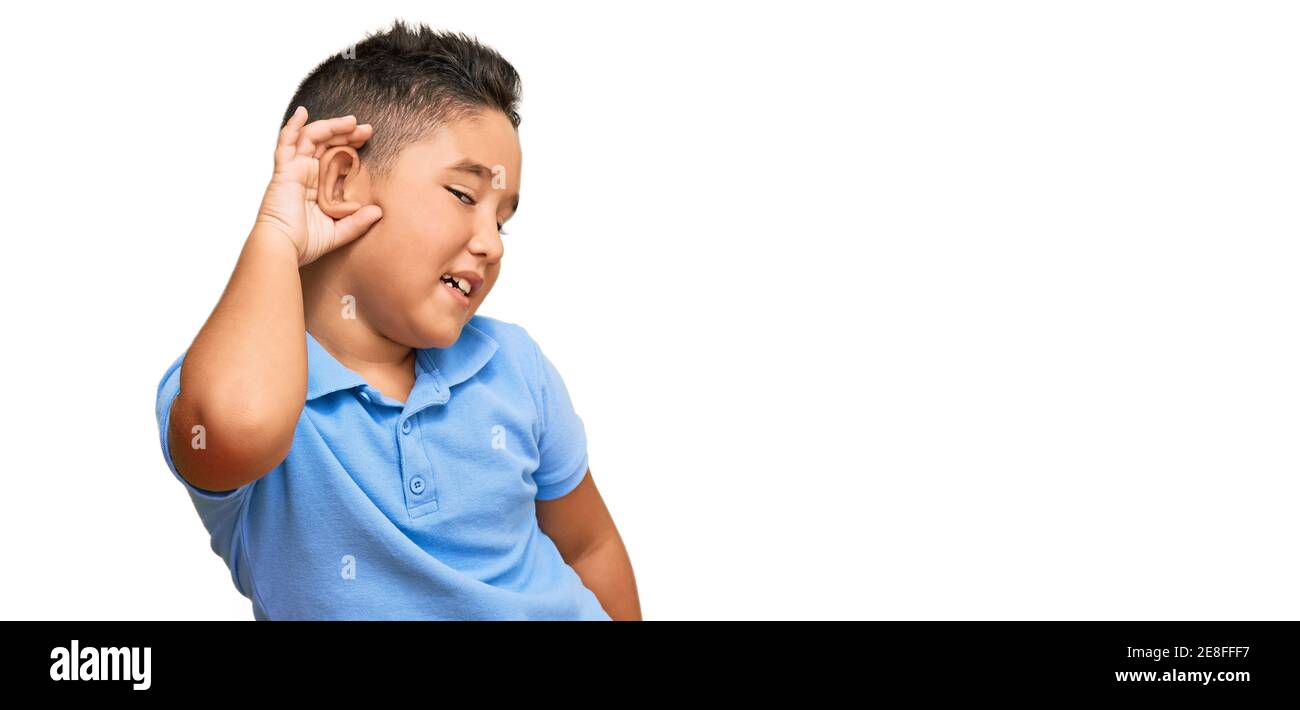 Hand to ear child listening hispanic Cut Out Stock Images & Pictures - Alamy
