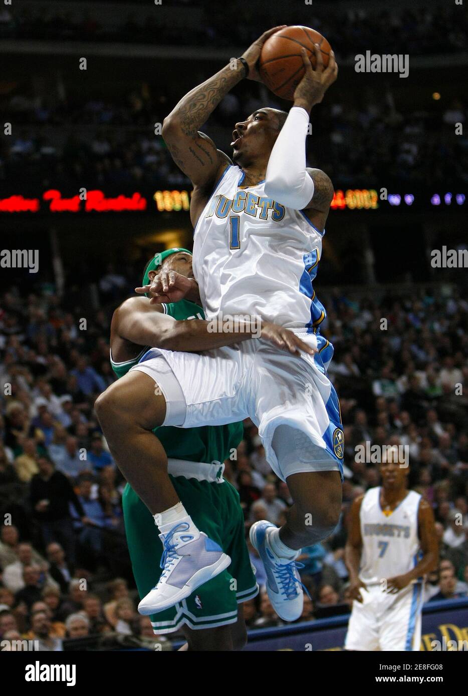 Denver Nuggets guard J.R.Smith (R) goes up past Boston Celtics forward Paul Pierce in their NBA basketball game in Denver February 23, 2009. REUTERS/Rick Wilking (UNITED STATES) Stock Photo
