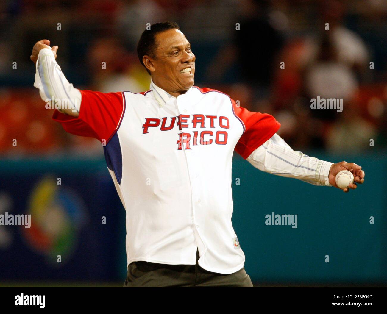Former MLB player Tony Perez throws out the ceremonial first pitch wearing  a Puerto Rico jersey before Team Puerto Rico met Team Venezuela in their  second round World Baseball Classic game in