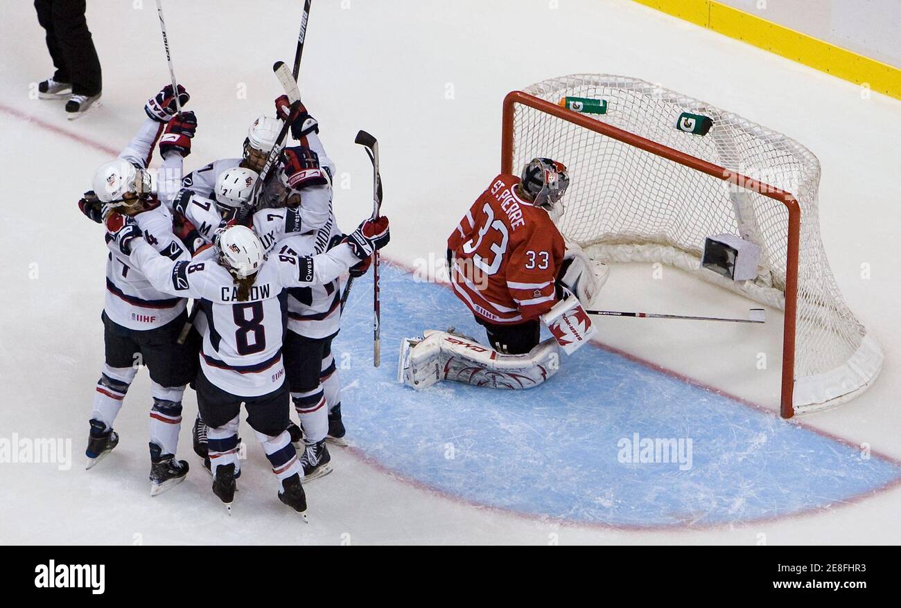 Members of Team U.S celebrate their goal scored by Monique Lamoureux on Canada's goalie Kim St-Pierre during first period play of the gold medal game at the Hockey Canada Cup in Vancouver, British Columbia  September 6, 2009. The IIHF exhibition tournament, which includes the top four women's teams from Canada, Sweden, Finland and the USA, is a test event for the upcoming 2010 Olympics. REUTERS/Andy Clark (CANADA SPORT ICE HOCKEY) Stock Photo