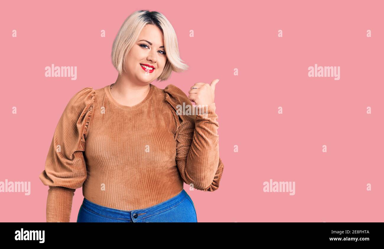 Young blonde plus size woman wearing casual sweater smiling with happy ...