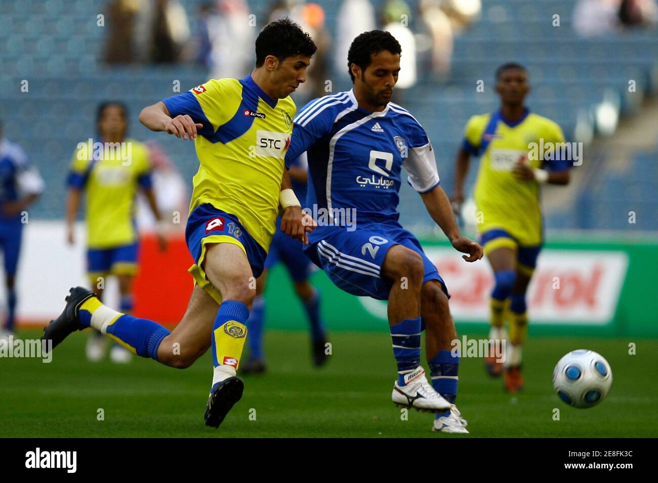 Al Hilal's Yasser Al Qahtani (R) fights for the ball with Al Nasr's Abdullah Al Qarni during their Saudi Super League soccer match in Riyadh December 31, 2009. REUTERS/Fahad Shadeed (SAUDI ARABIA - Tags: SPORT SOCCER) Stock Photo