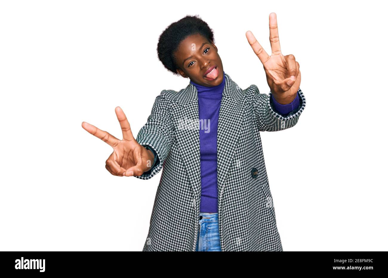 Young african american girl wearing casual clothes smiling with tongue ...