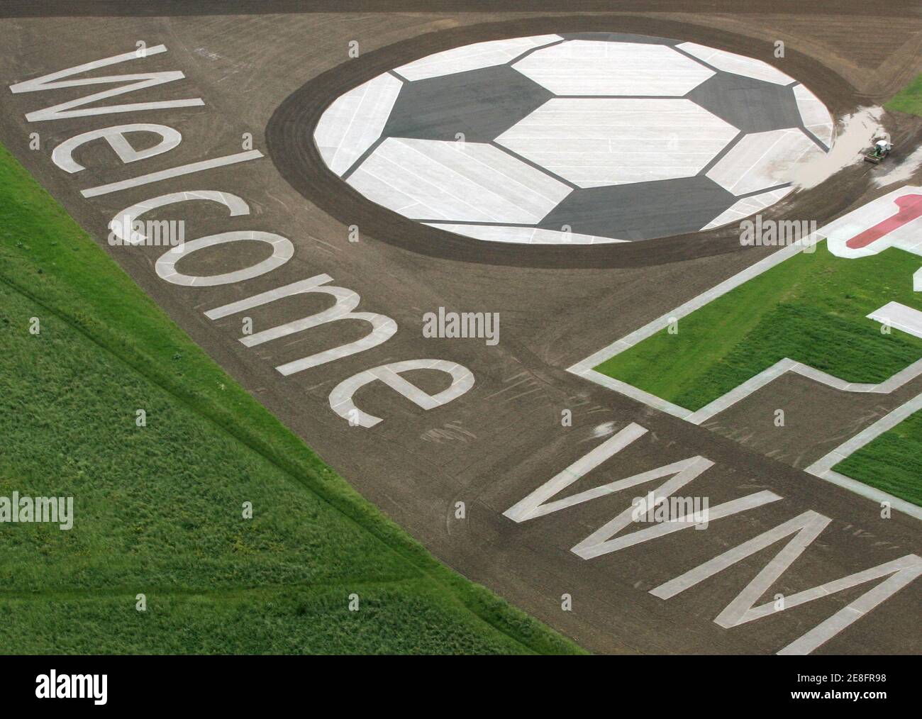 An aerial view shows a huge placard showing a soccer ball and the word  'Welcome WM' placed on a field near Frankfurt, May 30, 2006. The soccer  World Cup in Germany will