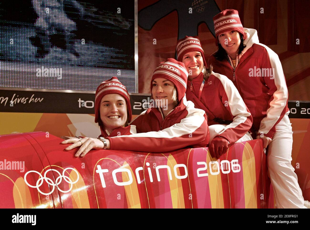 Members of Canada's women's hockey team sit in a bobsleigh following a ceremony at which the Canadian flag was raised in the athlete's village at the Torino 2006 Winter Olympic Games in Turin February 8, 2006. (From L to R)Gina Kingsbury, Sarah Vaillancourt, Kim St.Pierre and Caroline Ouellet.        REUTERS/Andy Clark Stock Photo