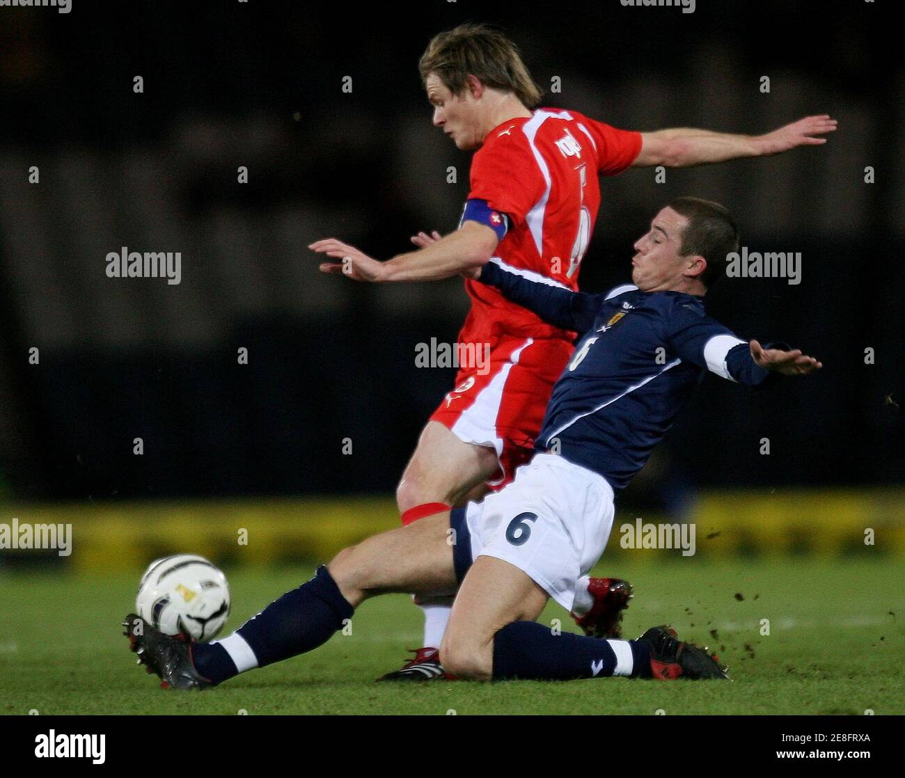 Switzerland's Johann Vogel (L) fights for the ball with Scotland's Barry Ferguson during their friendly soccer match at the Hampden Park stadium in Glasgow, Scotland, March 1, 2006. REUTERS/Pascal Lauener Stock Photo