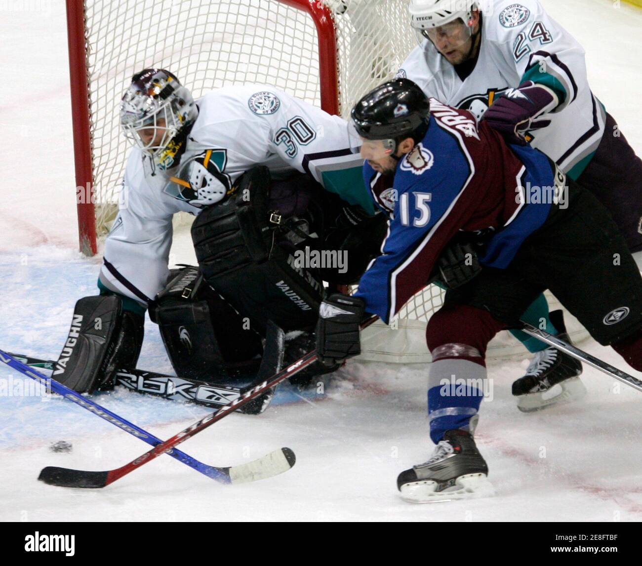 Colorado Avalanche winger Andrew Brunette (15) sets up the puck in front of Anaheim Mighty Ducks goalie Ilya Bryzgalov (L) at the end of the first period of the NHL semi-final playoff game in Denver May 9, 2006. Colorado's Dan Hinote scored on the play. Defending for the Ducks is Ruslan Salei (24). REUTERS/Rick Wilking Stock Photo