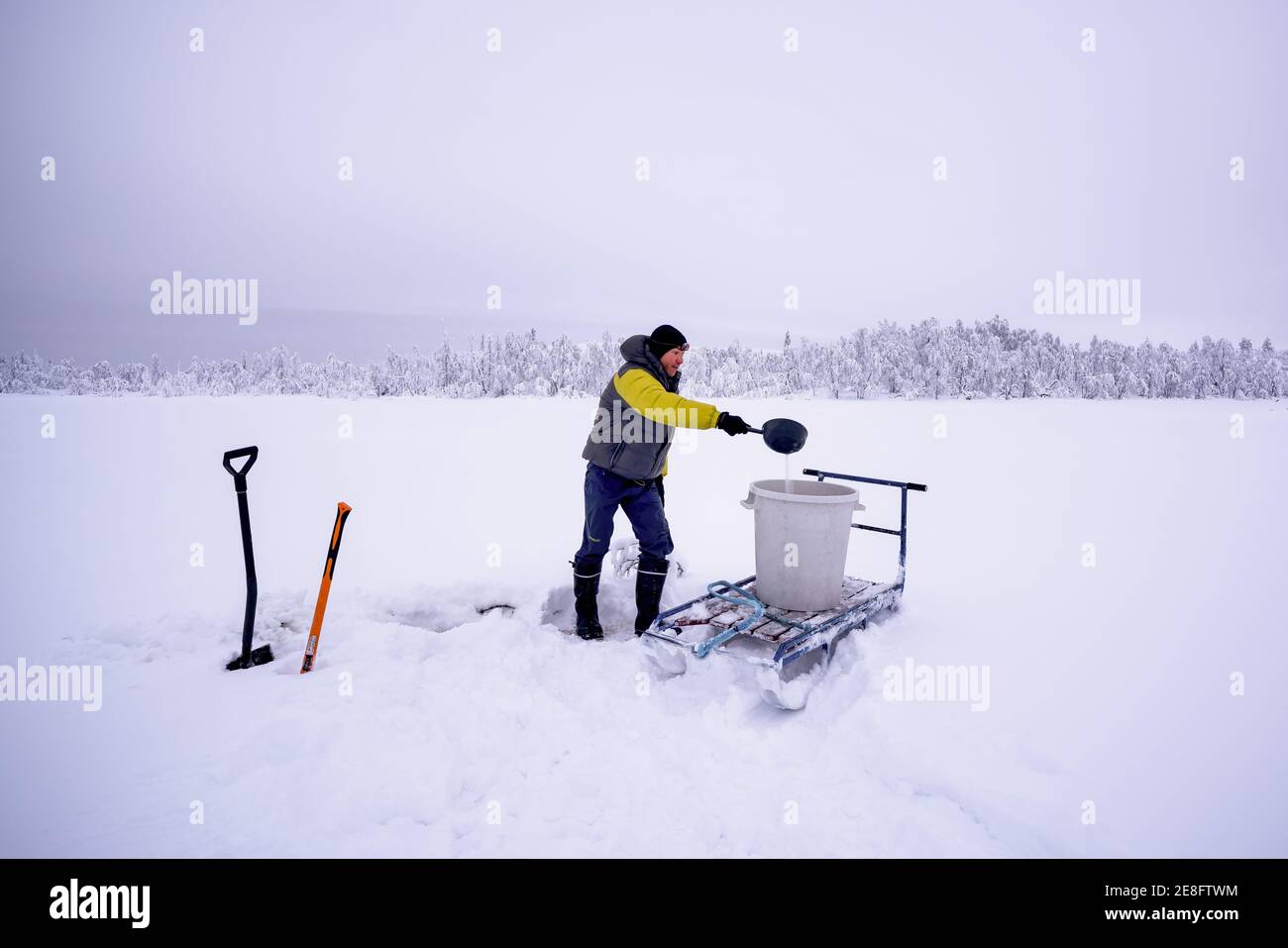 Getting water for the heating of sauna at Hannukuru, Enontekiö, Lapland, Finland Stock Photo