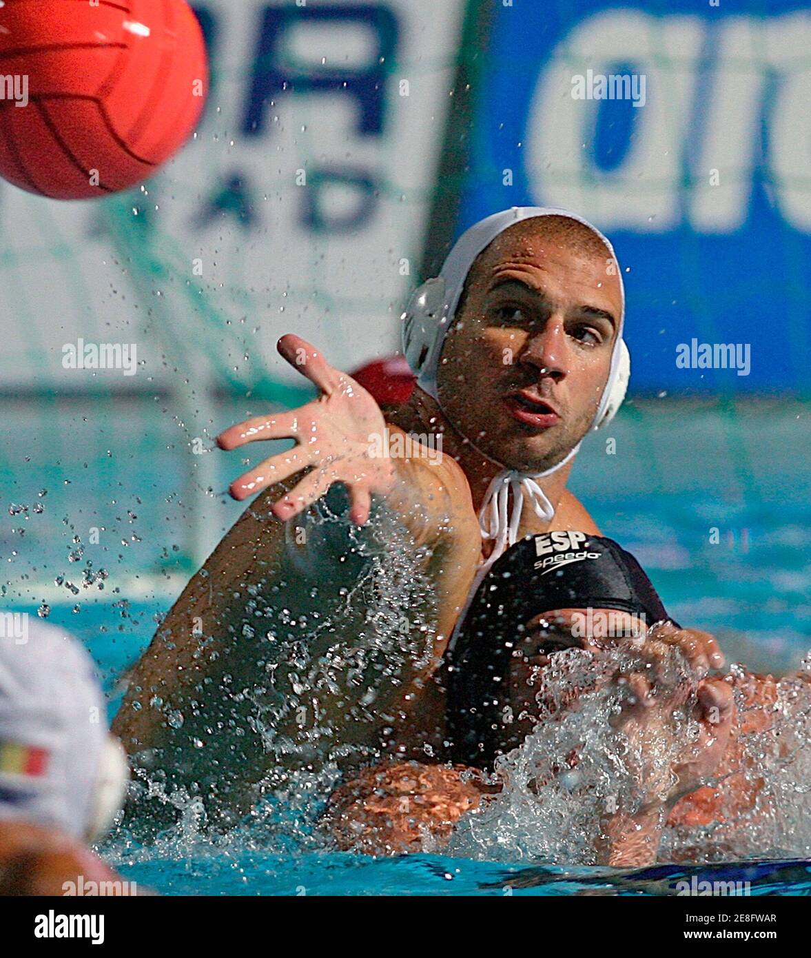 Romania's Florin Musat (L) struggles for the ball with Spain's Guillermo Molina during their bronze medal match in the water polo European Championship in Belgrade September 10, 2006.  REUTERS/Ivan Milutinovic (SERBIA) Stock Photo