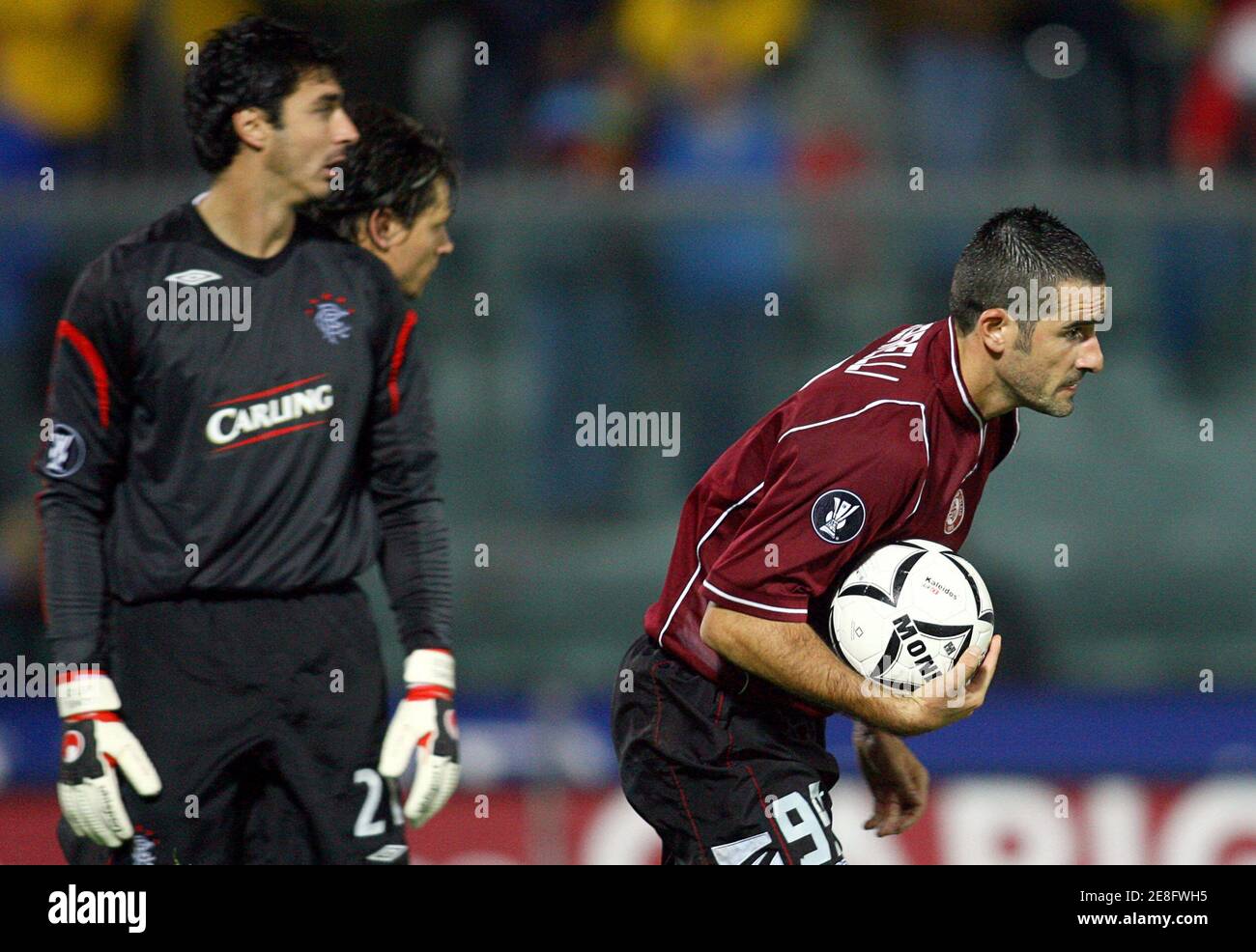 Livorno's Cristiano Lucarelli (R) celebrates after scoring as Rangers' goalkeeper Stefan Klos watches during their UEFA Cup Group A soccer match at the Armando Picchi Stadium in Livorno, October 19, 2006. Rangers won the match 3-2.     REUTERS/Giampiero Sposito (ITALY) Stock Photo