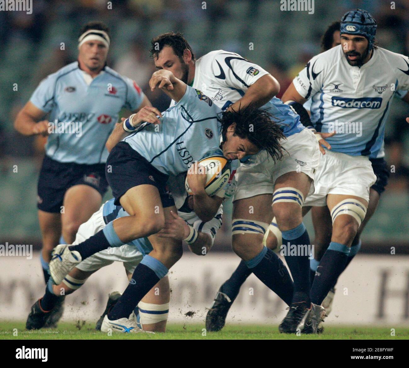 Daniel Halangahu of the Waratahs from Australia (2nd L) tries to break their defence of the Bulls from South Africa during their Super 14 rugby match in Sydney March 10, 2007. REUTERS/Will Burgess   (AUSTRALIA) Stock Photo