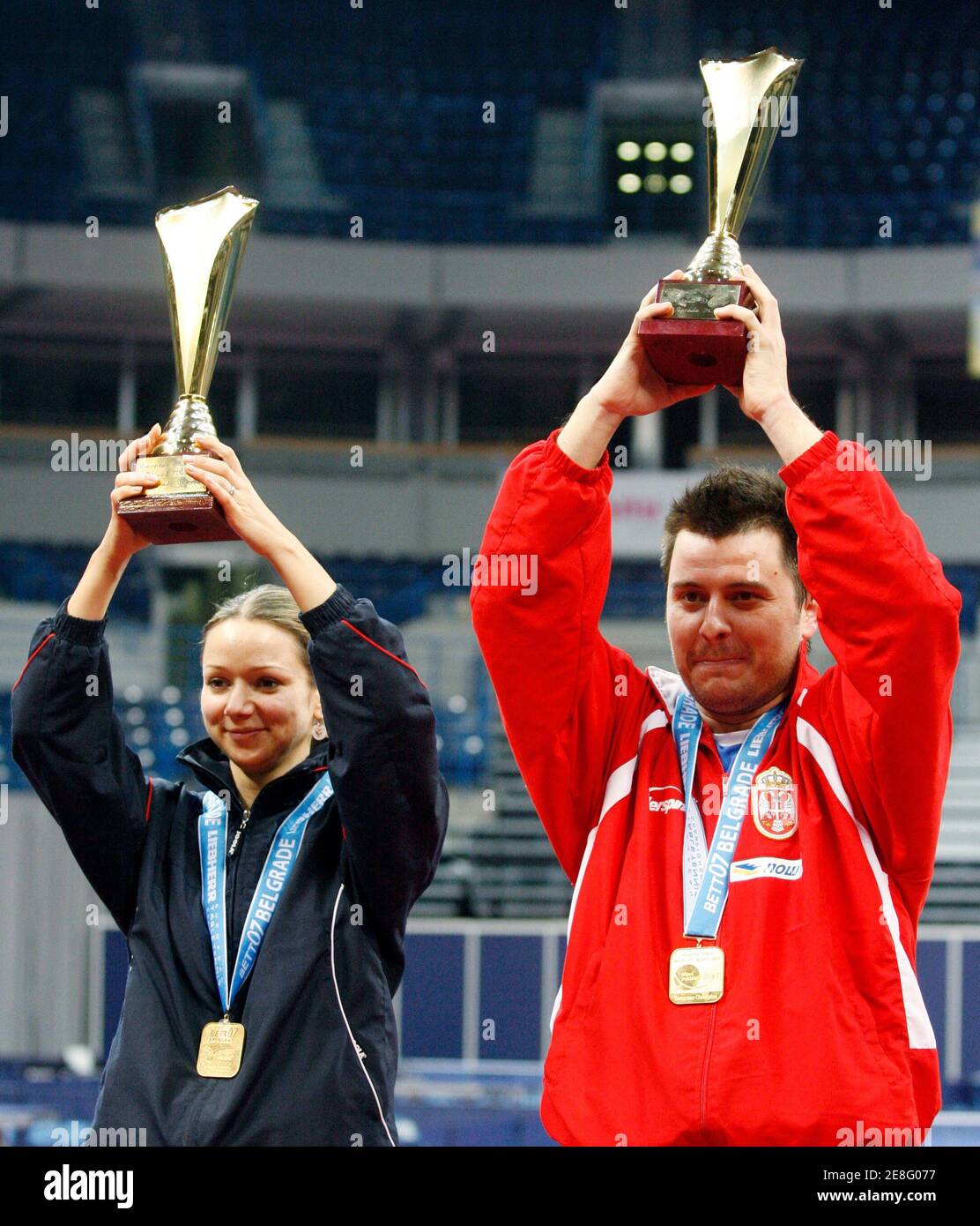 Lithuania's Ruta Paskauskiene (L) and Serbia's Aleksandar Karakasevic raise their trophies after winning the mixed doubles final match at the European Table Tennis Championships in Belgrade, March 30, 2007.  REUTERS/Ivan Milutinovic   (SERBIA) Stock Photo