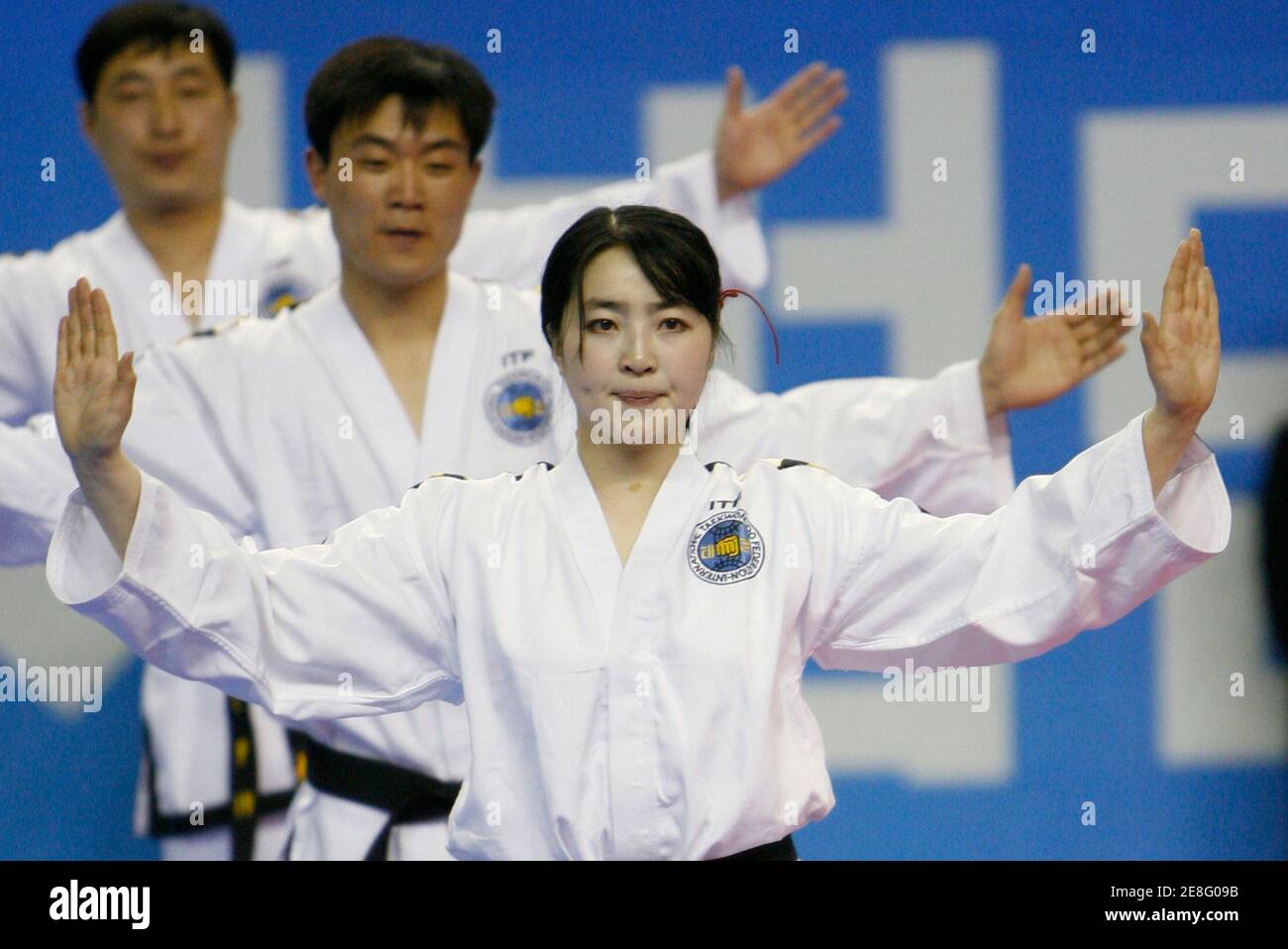 Members from a North Korean Taekwondo demonstration team perform on the stage in Chunchon, about 90 km (55 miles) northeast of Seoul, April 7, 2007. REUTERS/Jo Yong-Hak (SOUTH KOREA) Stock Photo