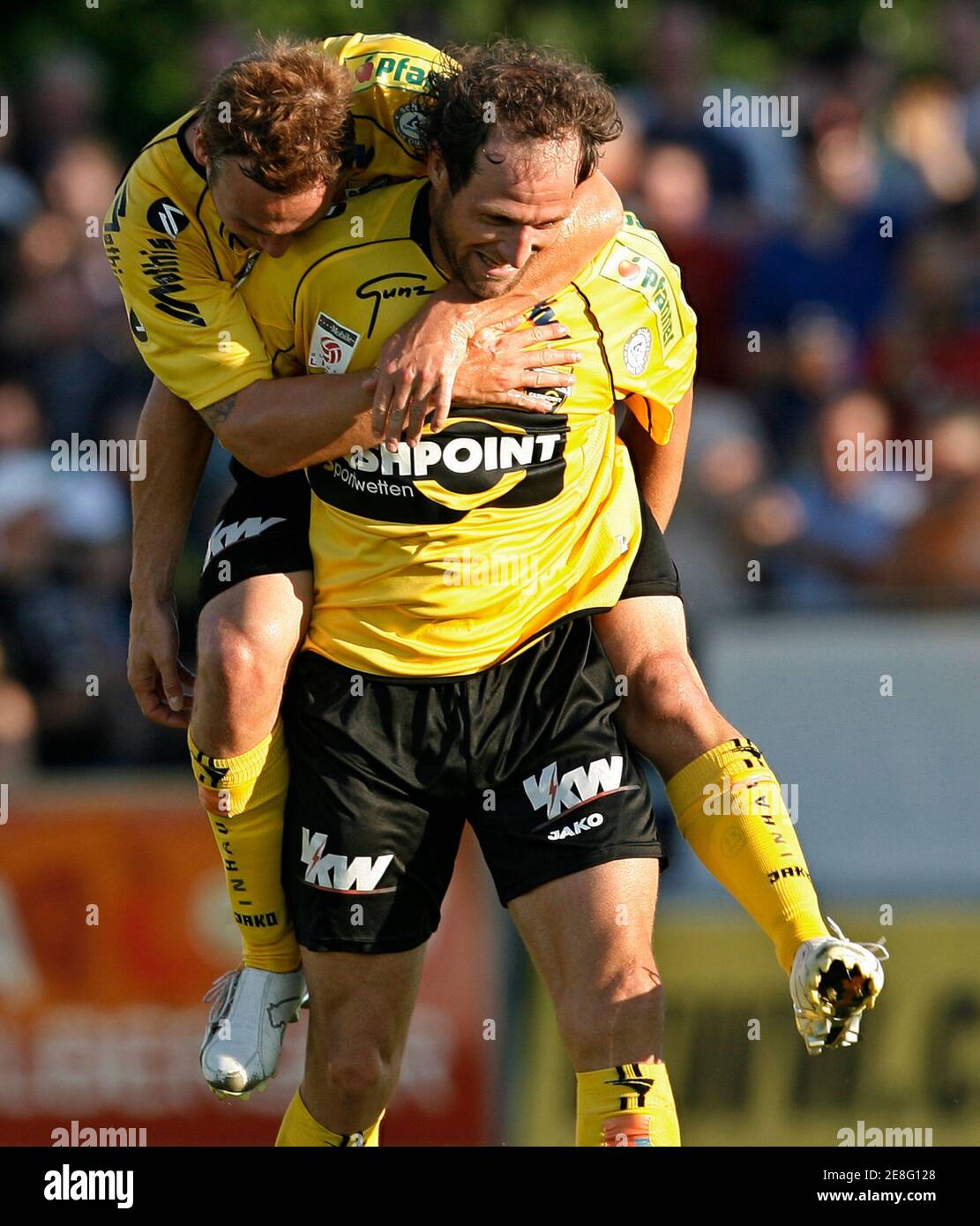Altach's Roland Kirchler (front) celebrates with team mate Kai Schoppitsch after scoring against Ried during their Austrian league soccer match in Altach July 14, 2007. REUTERS/Miro Kuzmanovic (AUSTRIA) Stock Photo