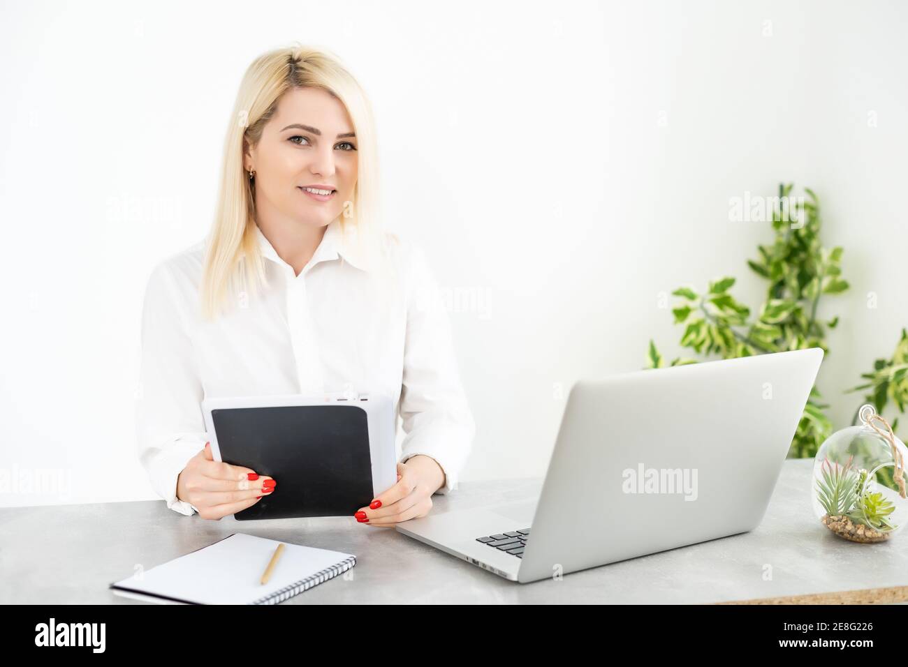 Beautiful young woman working on her laptop in her office Stock Photo ...