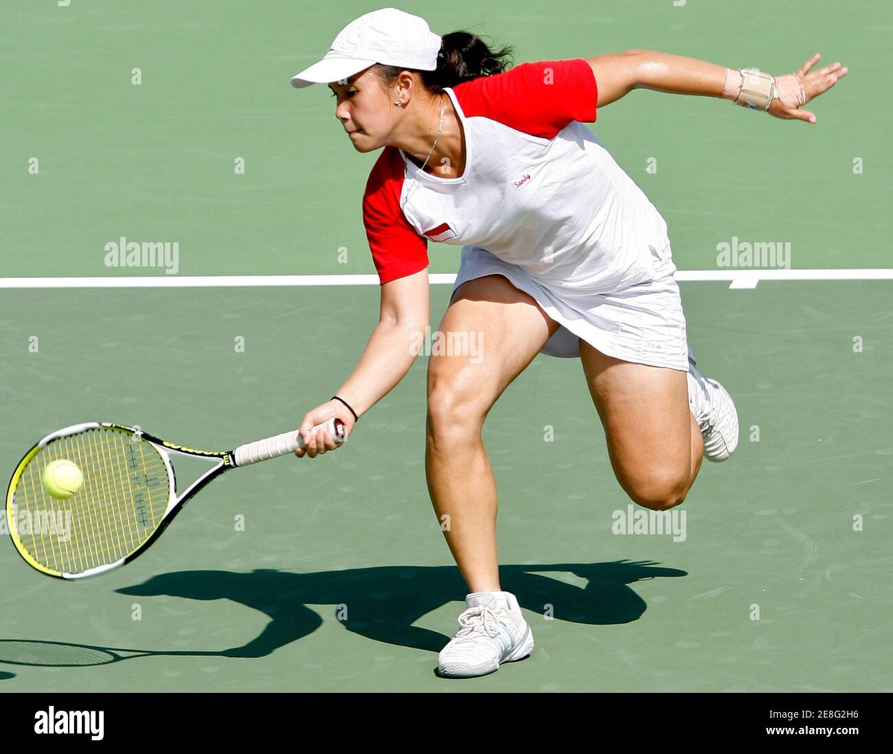 Indonesia'a Sandy Gumulya plays a shot against Thailand's Nudnida Luangnam during their women's singles tennis final match at the SEA Games in Nakhon Ratchasima December 14, 2007. Sandy won to take the gold. REUTERS/Chaiwat Subprasom (THAILAND) Stock Photo