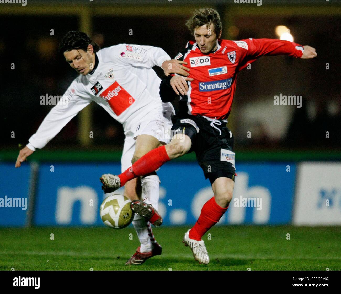 FC Thun's Andreas Gerber (L) challenges FC Aarau's Kristian Nushi during their Swiss Super League soccer match in Thun March 19, 2008. REUTERS/Pascal Lauener (SWITZERLAND) Stock Photo
