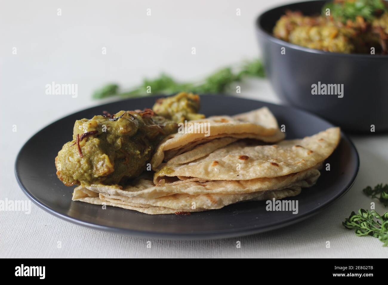 Homemade spicy coriander chicken served with Indian flat bread for
