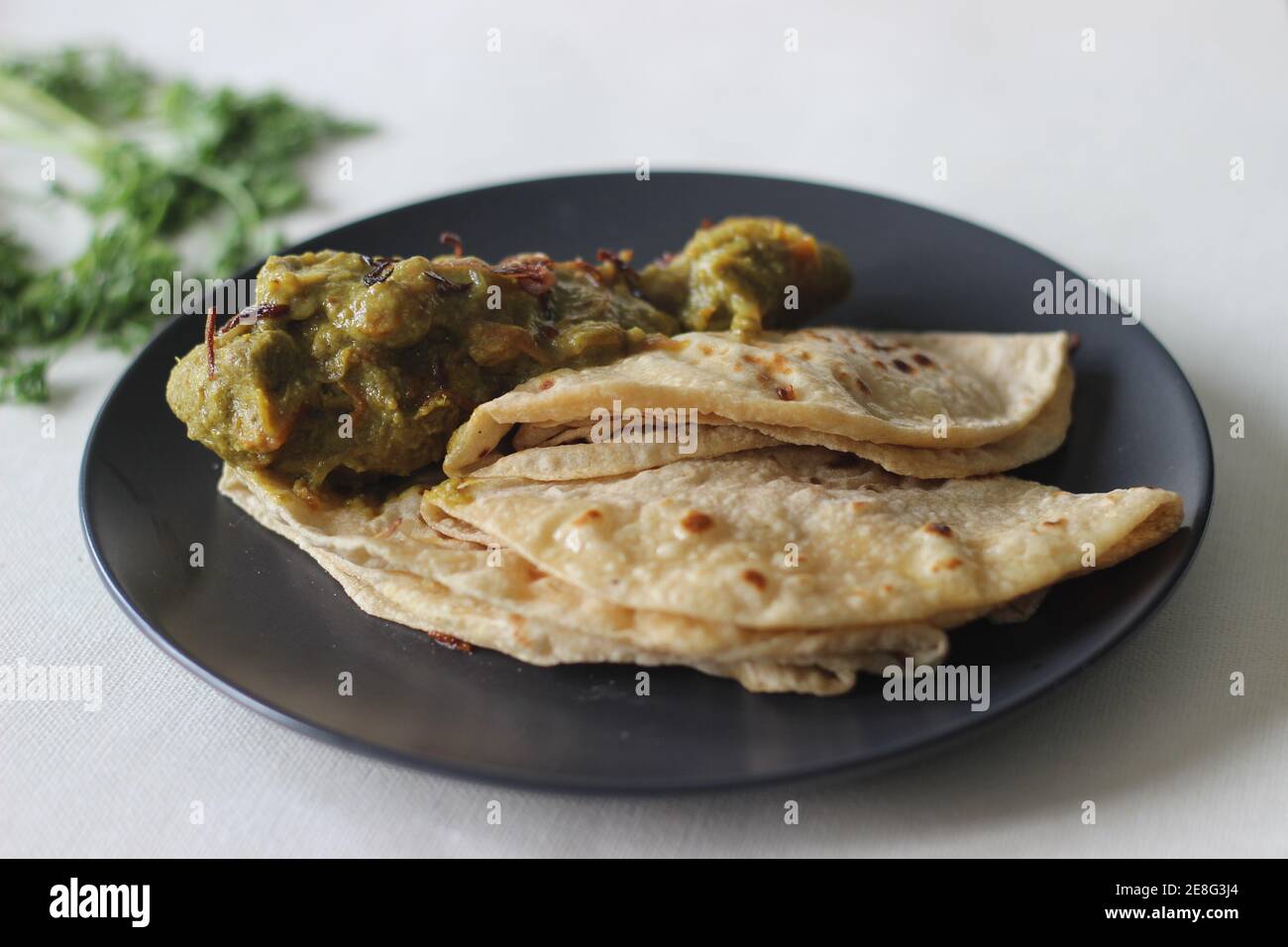 Homemade spicy coriander chicken served with Indian flat bread for