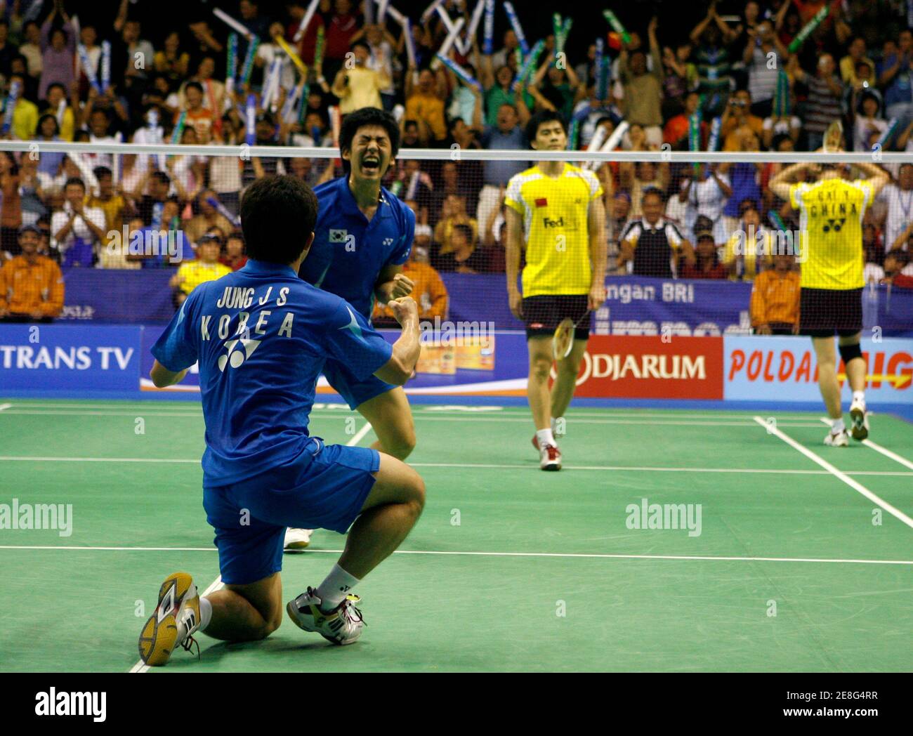 South Korea's Jung Jae-sung (L) and Lee Yong Dae react after beating China's Fu Haifeng and Cai Yun in the doubles final of their Thomas Cup badminton tournament match in Jakarta May 18, 2008. REUTERS/Beawiharta (INDONESIA) Stock Photo