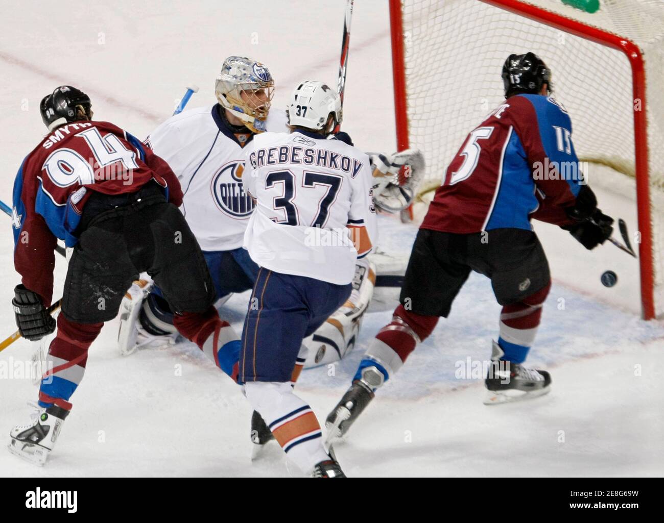 Colorado Avalanche winger Andrew Brunette (R) scores a goal over Edmonton Oilers goaltender Dwyane Roloson (2nd L) in the first period of the NHL hockey game in Denver, Colorado March 28, 2008. Also on the play are Colorado's Ryan Smyth (94) and Edmonton's Denis Grebeshkov (37).   REUTERS/Rick Wilking (UNITED STATES) Stock Photo