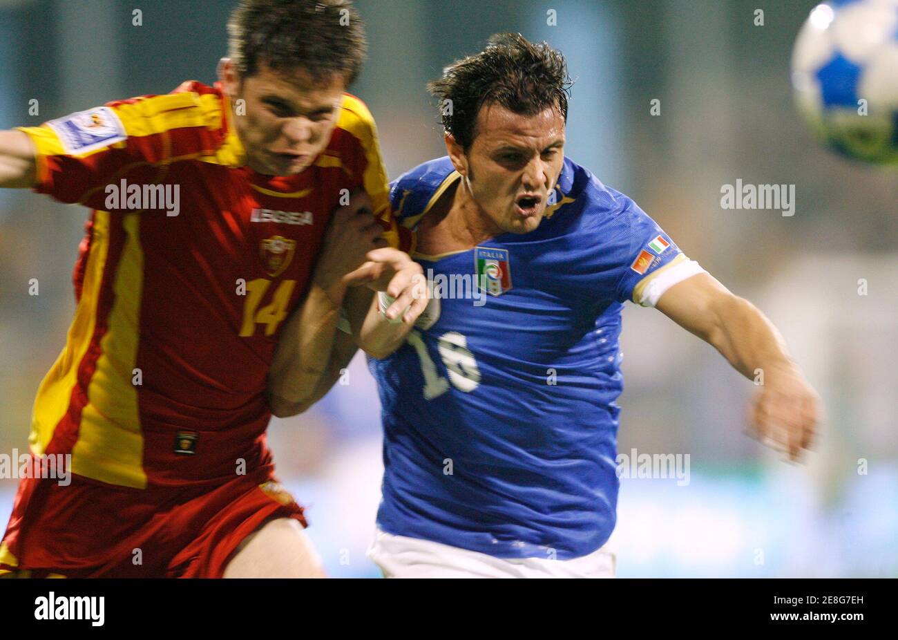 Italy's Simone Pepe (R) is challenged by Montenegro's Vladimir Bozovic during their 2010 World Cup qualifying soccer match in Podgorica March 28, 2009.  REUTERS/Ivan Milutinovic (MONTENEGRO SPORT SOCCER) Stock Photo