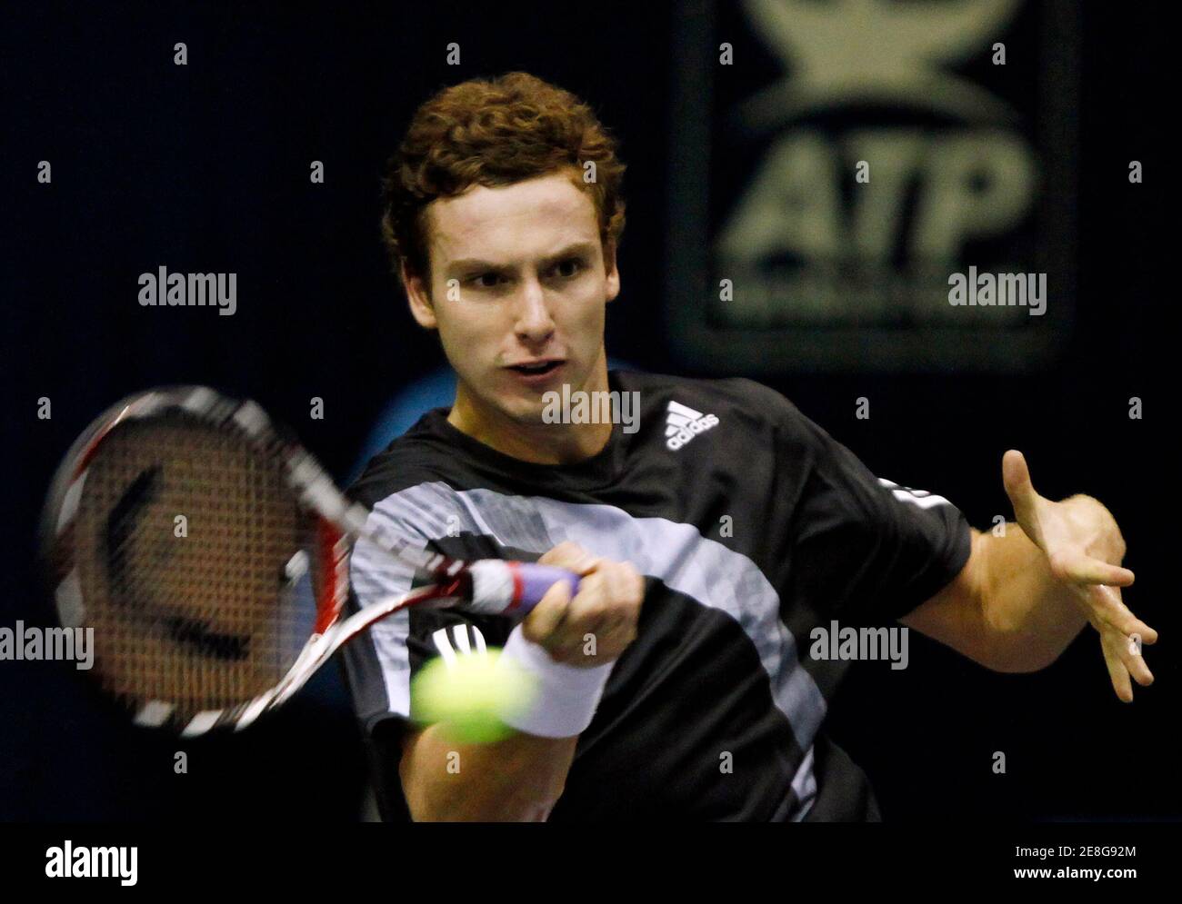 Ernests Gulbis of Latvia returns a shot to Somdev Devvarman of India during their first round match at the Thailand Open tennis tournament in Bangkok September 29, 2009. REUTERS/Chaiwat Subprasom (THAILAND SPORT TENNIS) Stock Photo