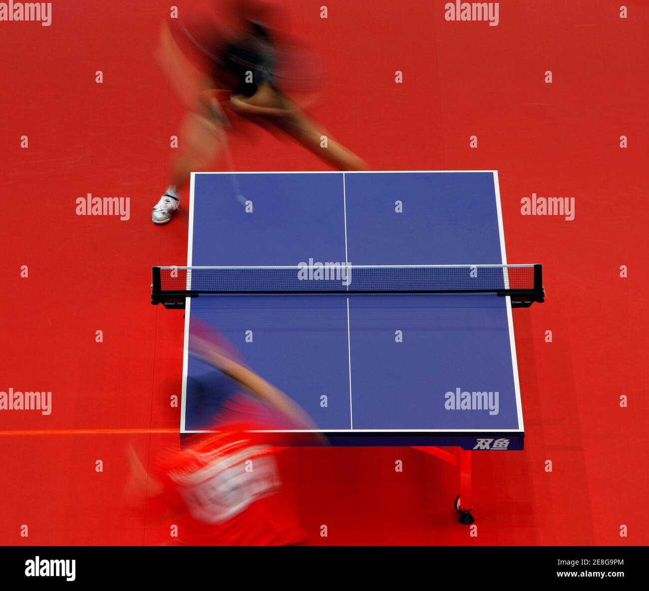 China's Wang Hao returns a shot to Japan's Jun Mizutani (top) during the East Asian Games men's team table tennis qualifiers in Hong Kong December 3, 2009.    REUTERS/Tyrone Siu    (CHINA SPORT TABLE TENNIS IMAGES OF THE DAY) Stock Photo