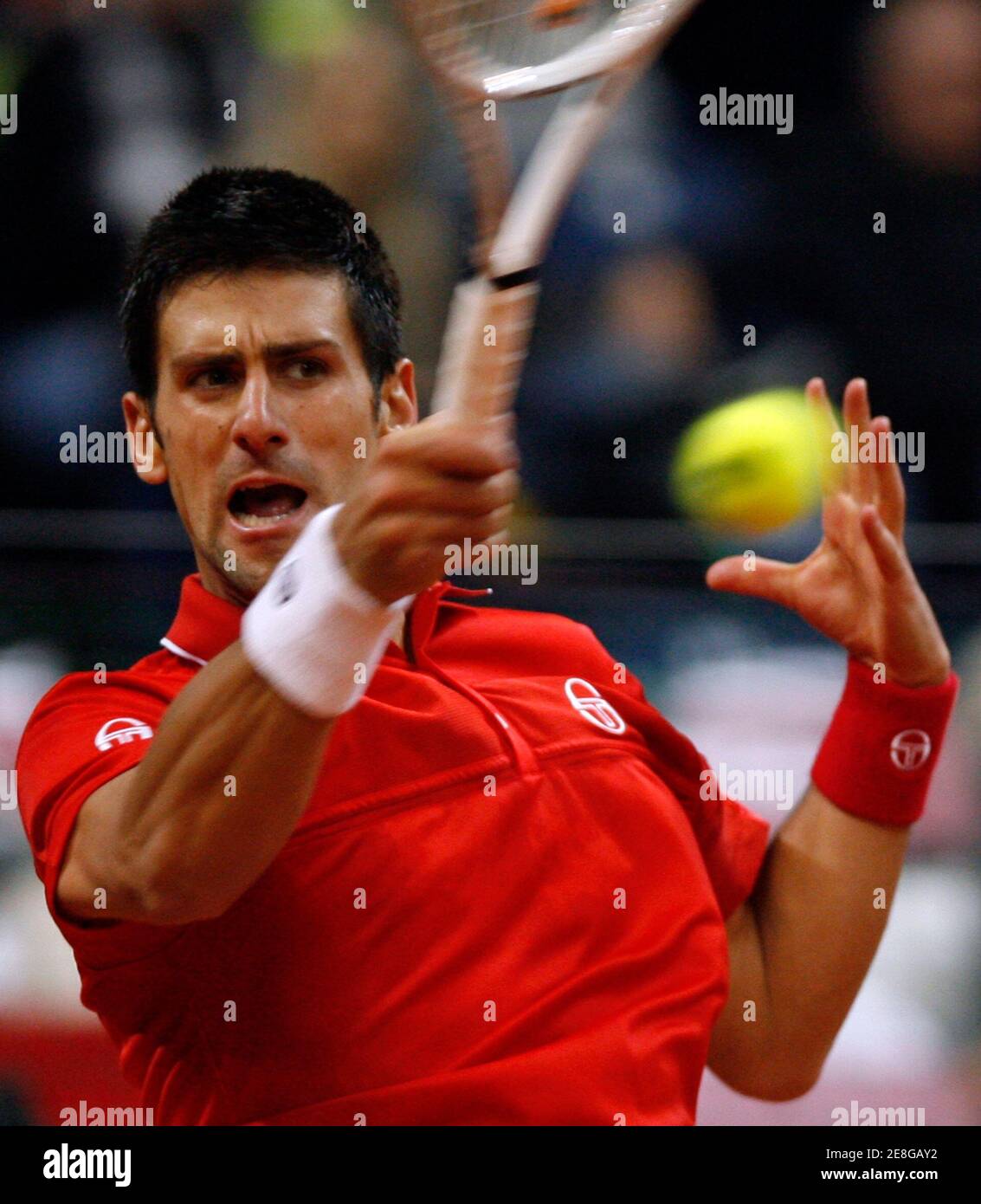 Serbia's Novak Djokovic hits a return against Sam Querrey of the U.S. during their Davis Cup World Group tennis match in Belgrade March 5, 2010.    REUTERS/Ivan Milutinovic (SERBIA - Tags: SPORT TENNIS) Stock Photo