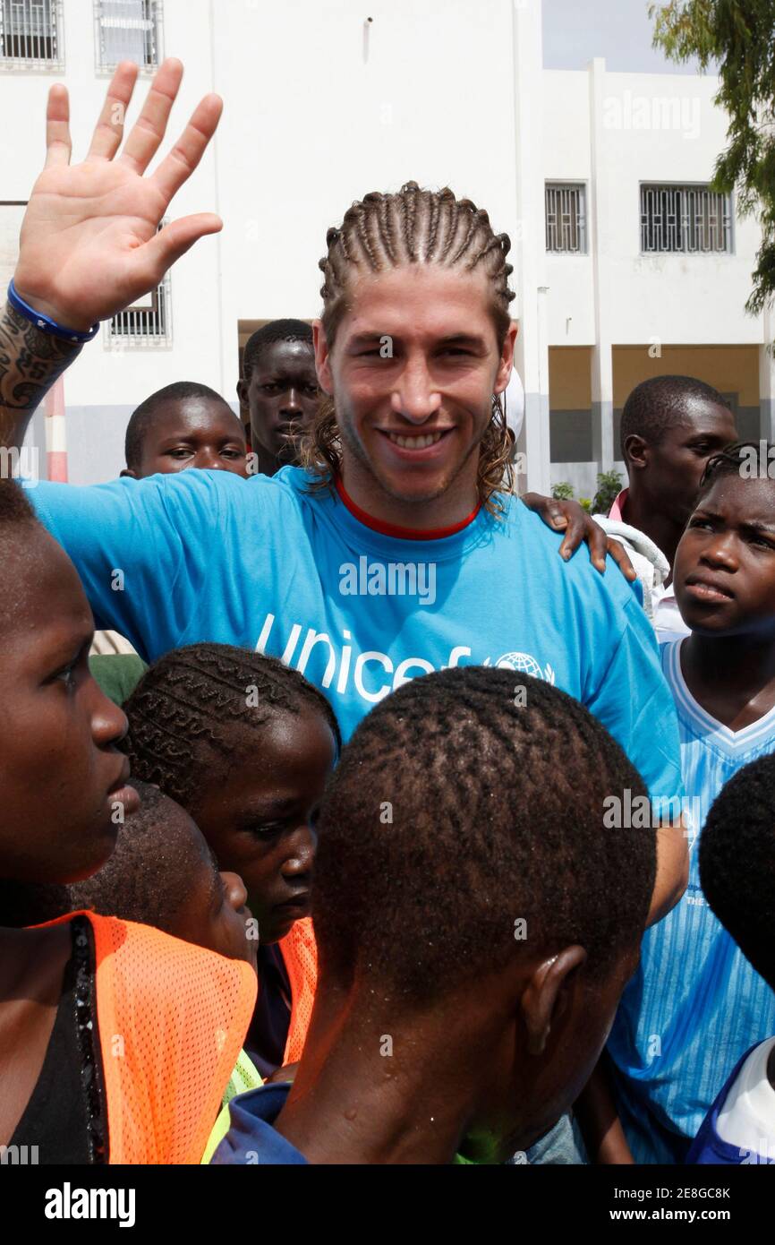 World Cup soccer champion and Real Madrid defender Sergio Ramos of Spain greets Senegalese youth during his four-day visit to Dakar as a goodwill ambassador for UNICEF July 18, 2010. REUTERS/Emmanuel Braun (SENEGAL - Tags: SPORT SOCCER) Stock Photo