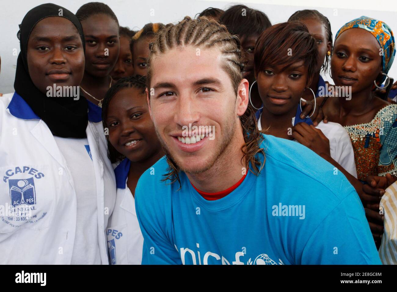 World Cup soccer champion and Real Madrid defender Sergio Ramos of Spain poses with Senegalese youth during his four-day visit to Dakar as a goodwill ambassador for UNICEF July 18, 2010. REUTERS/Emmanuel Braun (SENEGAL - Tags: SPORT SOCCER) Stock Photo