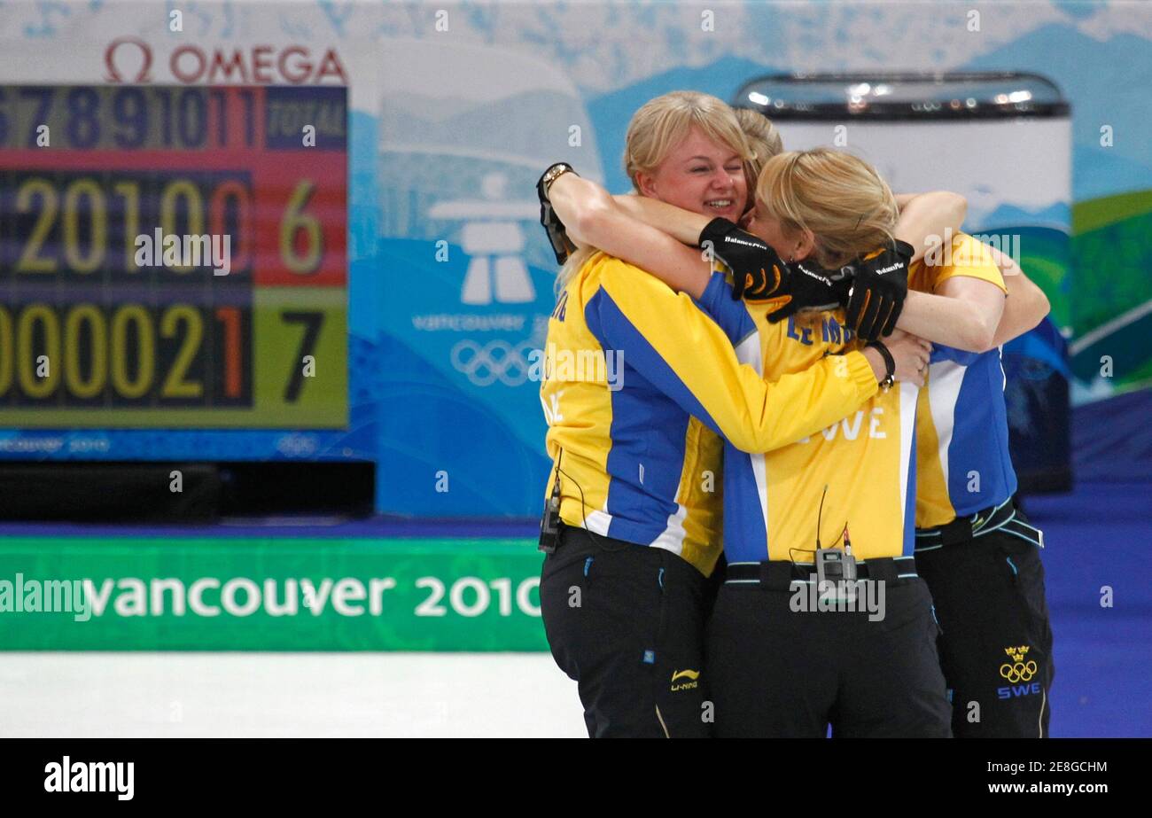 Sweden's skip Anette Norberg (L) celebrates with teammates after defeating Canada in an extra end in the women's curling finals at the Vancouver 2010 Winter Olympics, February 26, 2010.     REUTERS/Andy Clark (CANADA) Stock Photo