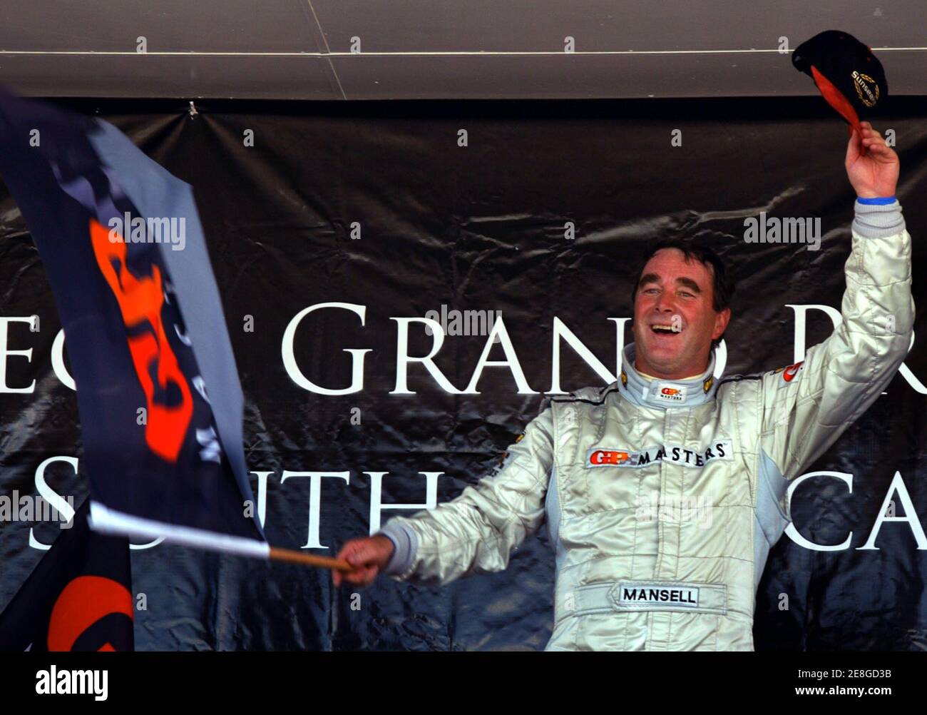 Briton Nigel Mansell celebrates after winning the Grand Prix Masters race at the Kyalami circuit near Johannesburg November 13, 2005. Mansell, 52, led the 30-lap race from start to finish and held off the challenge of Brazil's Emerson Fittipaldi to win by less than half-a-second. REUTERS/Juda Ngwenya Stock Photo