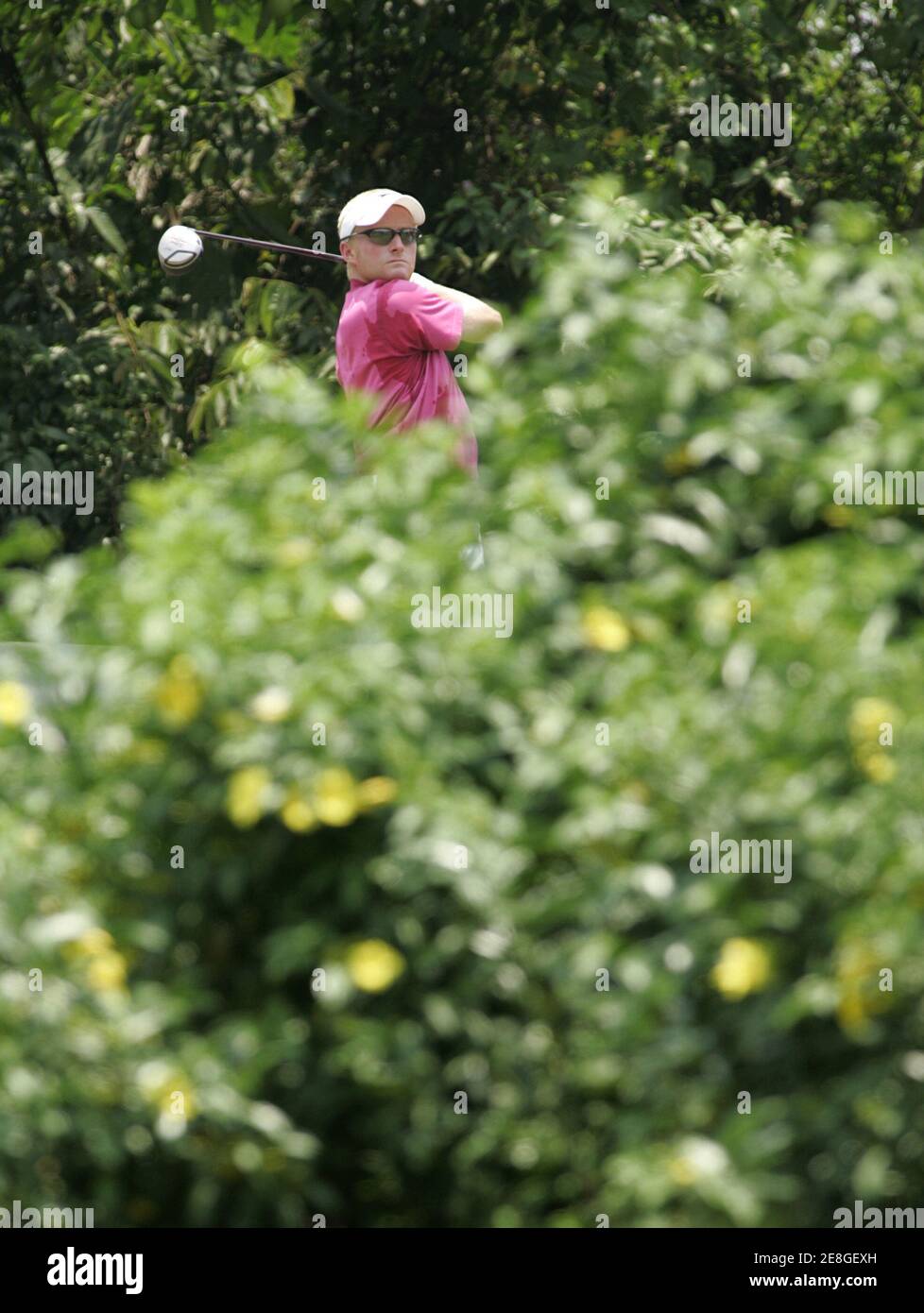 Simon Dyson of Britain watches his drives on the sixth hole during the final round of Indonesia Open golf tournament at Emeralda Golf Club in Cimanggis, West Java province March 5, 2006. REUTERS/Beawiharta Stock Photo