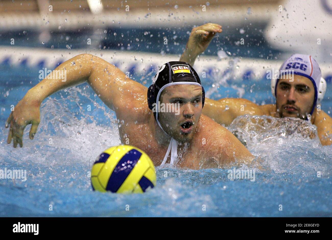 Heiko Nossek (L) of Germany struggles for the ball with Nikola Radjen of Serbia & Montenegro during their friendly water polo match as part of preparations for the upcoming European Waterpolo Championships in Belgrade March 8, 2006. REUTERS/Ivan Milutinovic Stock Photo