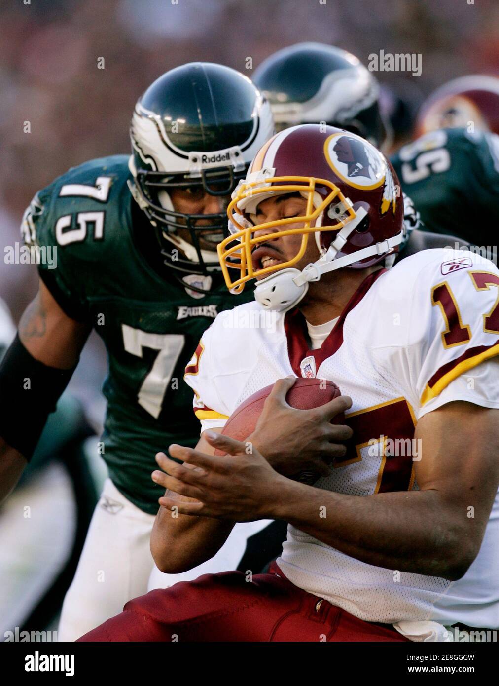 Washington Redskins quarterback Jason Campbell (R) is sacked by Philadelphia Eagles defensive end Juqua Thomas (75) in the first half of their NFL football game in Landover, Maryland December 10, 2006.      REUTERS/Gary Cameron  (UNITED STATES) Stock Photo