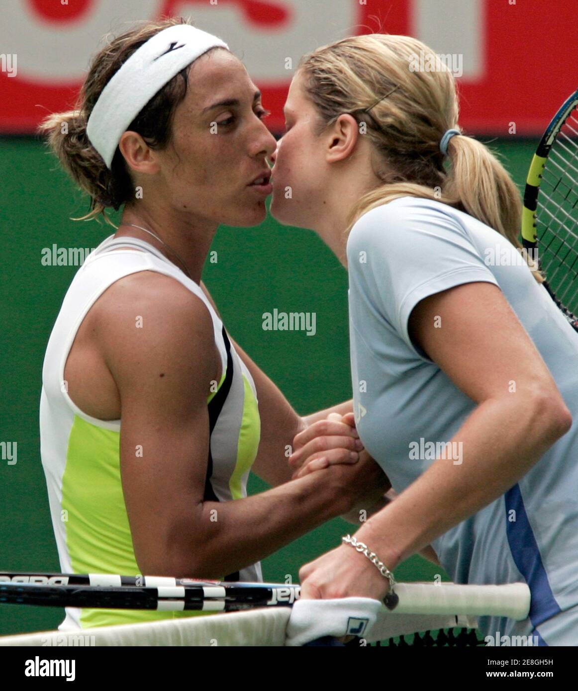 Kim Clijsters of Belgium (R) and Francesca Schiavone of Italy kiss at the  conclusion of their