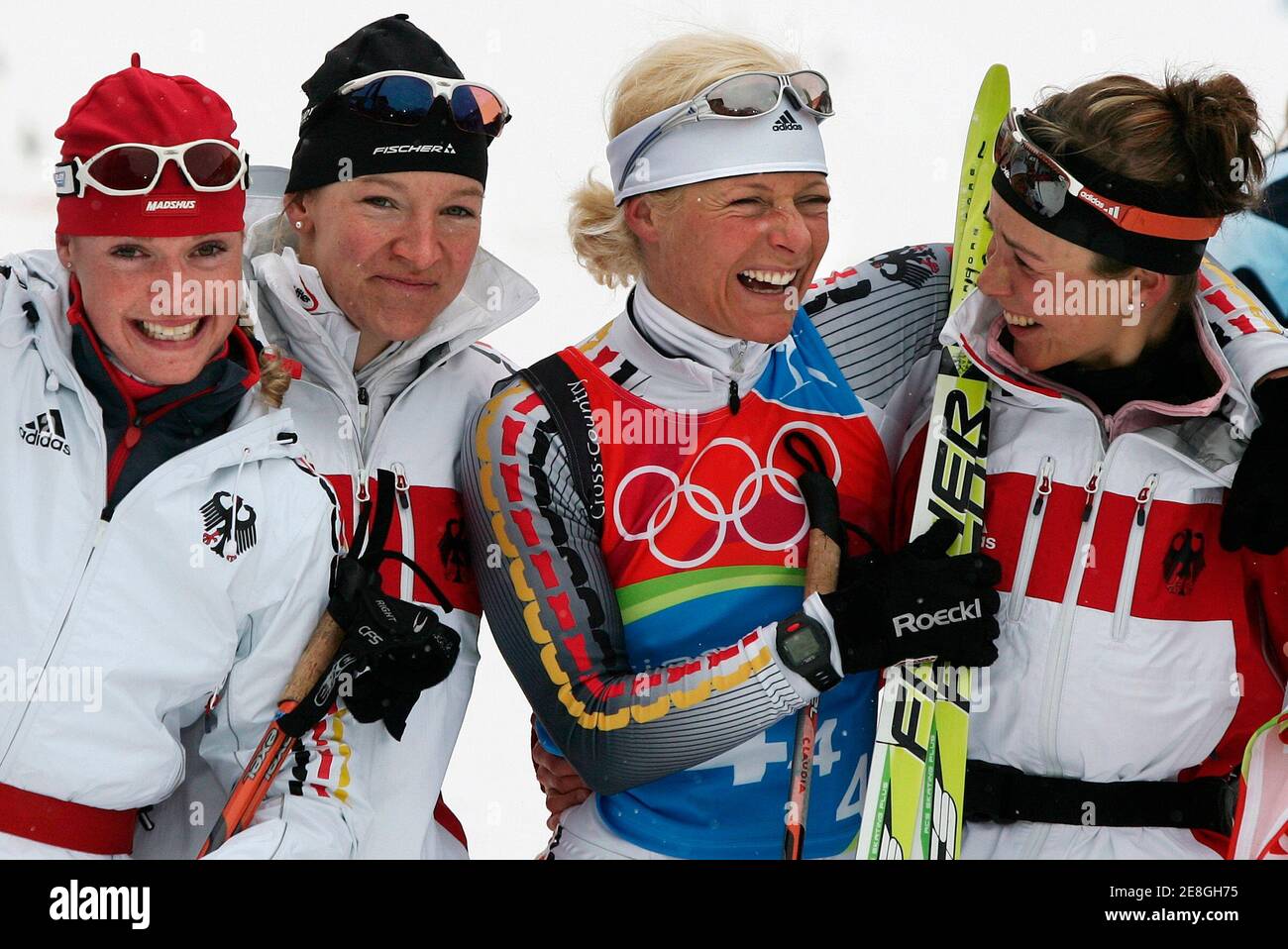 Germany's Evi Sachenbacher-Stehler, Viola Bauer, Claudia Kuenzel and Stefanie Boehler (L-R) celebrate winning the silver medal in the women's 4x5km relay cross country race at the Torino 2006 Winter Olympic Games in Pragelato, Italy, February 18, 2006. Russia won ahead of Germany and Italy. REUTERS/Pascal Lauener Stock Photo