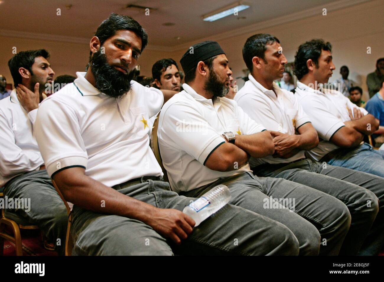 Members of the Pakistan team, including Mohammad Yousuf (L), Younis Khan (2nd R) and Azhar Mahmood (R) listen to team captain Insamam-ul-Haq during a news conference in Kingston March 18, 2007.  Inzamam-ul-Haq had planned to discuss his future with coach Bob Woolmer on Sunday and was left shattered by the Englishman's sudden death following the team's shock World Cup exit.   REUTERS/Andy Clark   (JAMAICA) Stock Photo
