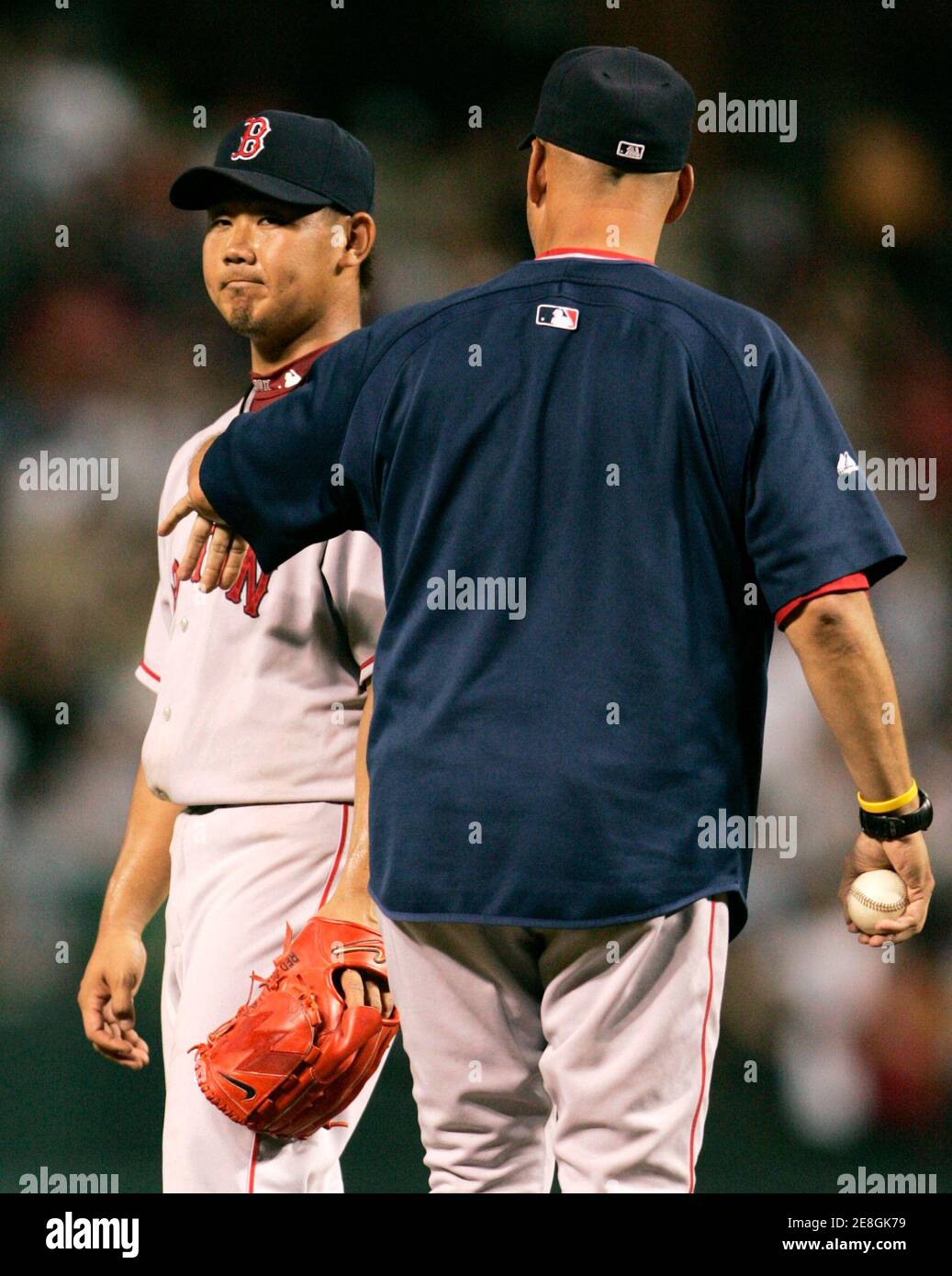 Boston Red Sox starting pitcher Daisuke Matsuzaka (L) is taken out of the game by manager Terry Francona after giving up seven runs to the Baltimore Orioles in the third inning of their MLB American League baseball game in Baltimore, Maryland September 8, 2007.     REUTERS/Gary Cameron    (UNITED STATES) Stock Photo