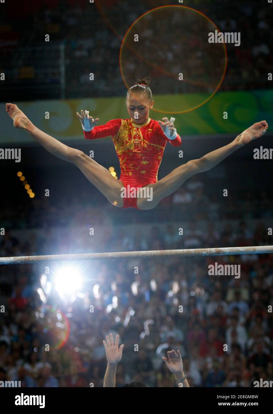 Yang Yilin of China competes on the uneven bars in the women's team