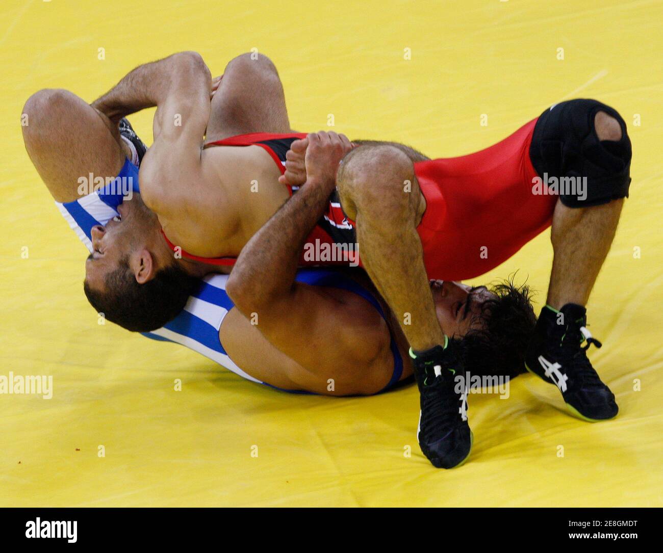 Saleh Emara of Egypt (in red) fights Saeid Abrahimi of Iran during their 96kg men's freestyle wrestling qualification match at the Beijing 2008 Olympic Games August 21, 2008. REUTERS/Oleg Popov (CHINA) Stock Photo