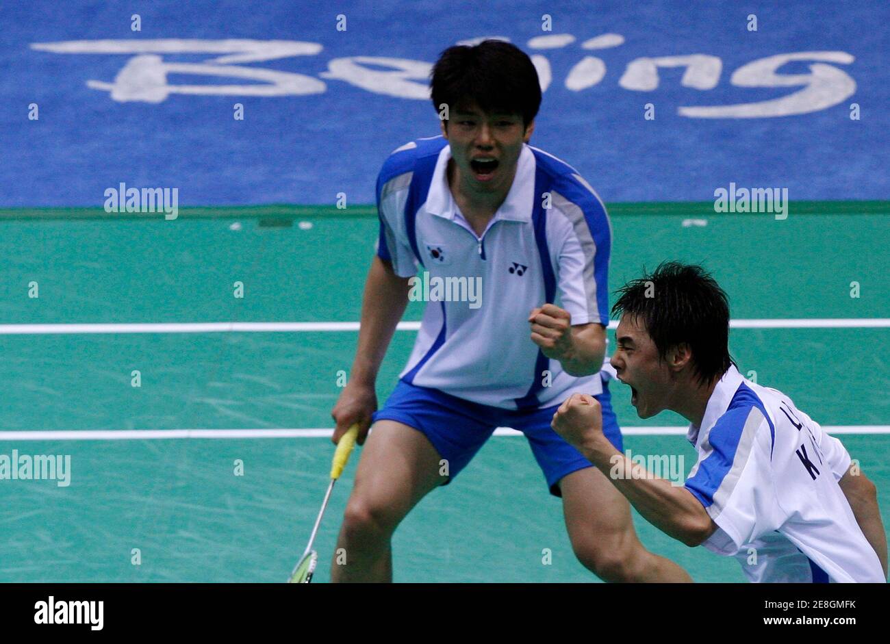 Lee Jaejin (R) and Hwang Jiman of South Korea celebrate after winning their men's doubles bronze medal badminton match against Jonas Rasmussen and Lars Paaske of Denmark at the Beijing 2008 Olympic Games, August 16, 2008.     REUTERS/Beawiharta (CHINA) Stock Photo